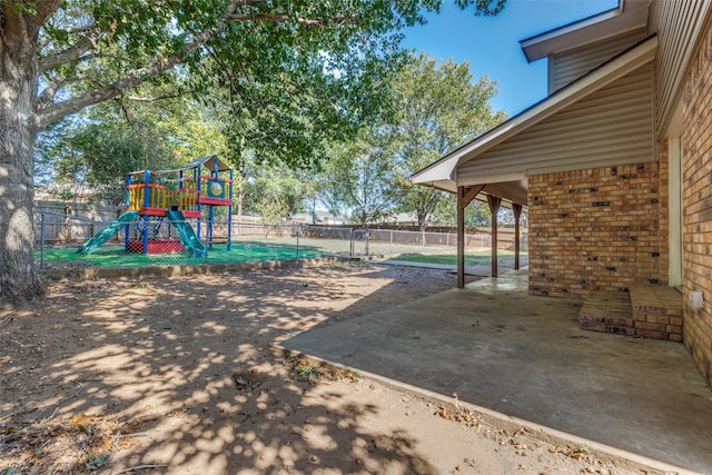 view of jungle gym featuring a patio