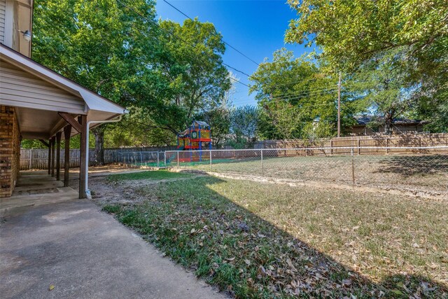 view of playground with a lawn