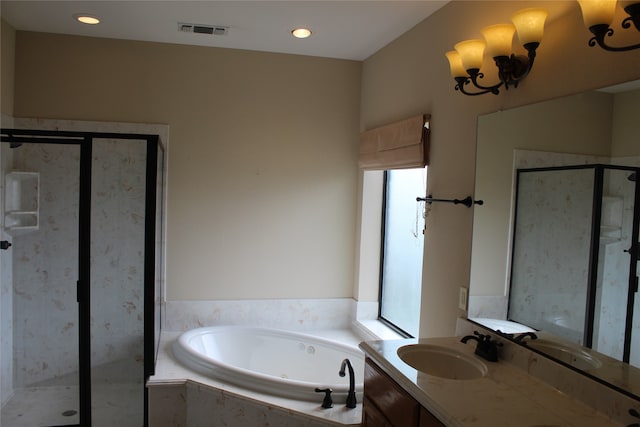 bathroom featuring vanity and shower with separate bathtub