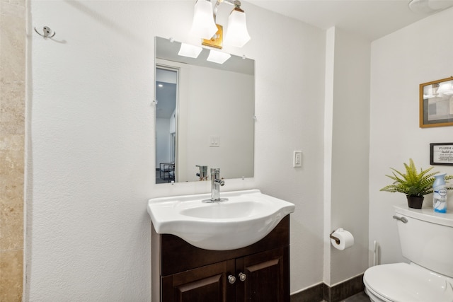 bathroom featuring vanity and toilet