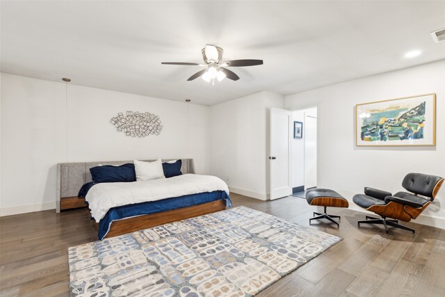 bedroom with dark hardwood / wood-style flooring and ceiling fan