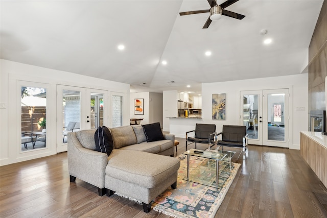 living room featuring vaulted ceiling, dark hardwood / wood-style floors, ceiling fan, and french doors