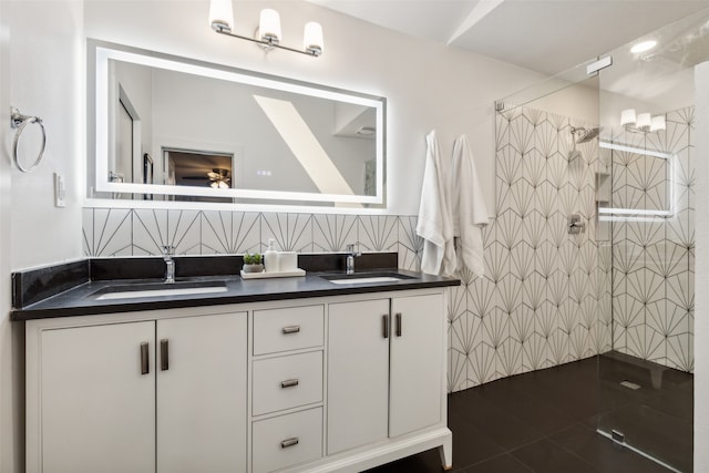 bathroom with tiled shower, vanity, and tasteful backsplash