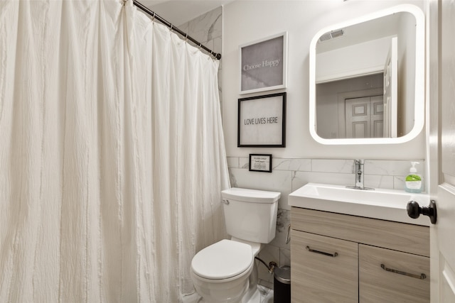 bathroom featuring tile walls, a shower with curtain, vanity, and toilet