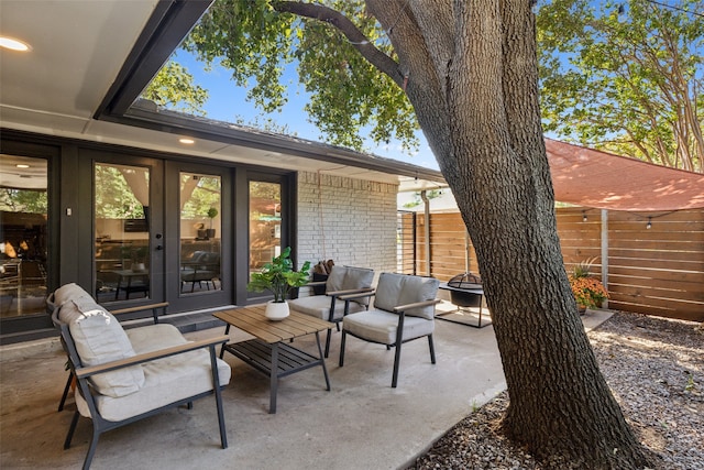 view of patio featuring an outdoor living space and french doors