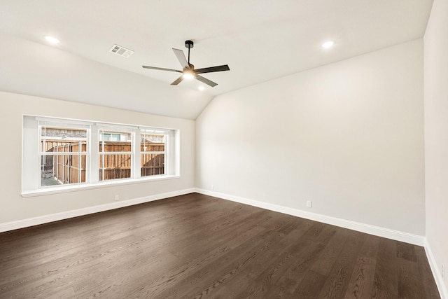 spare room with vaulted ceiling, dark wood-type flooring, and ceiling fan