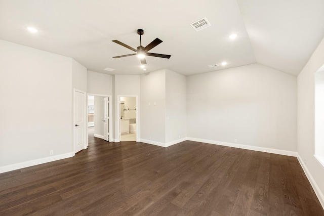 spare room with vaulted ceiling, dark hardwood / wood-style floors, and ceiling fan