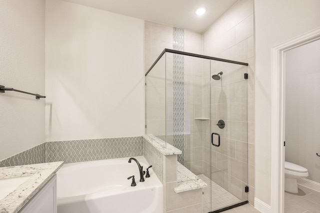 full bathroom featuring independent shower and bath, vanity, tile patterned floors, and toilet