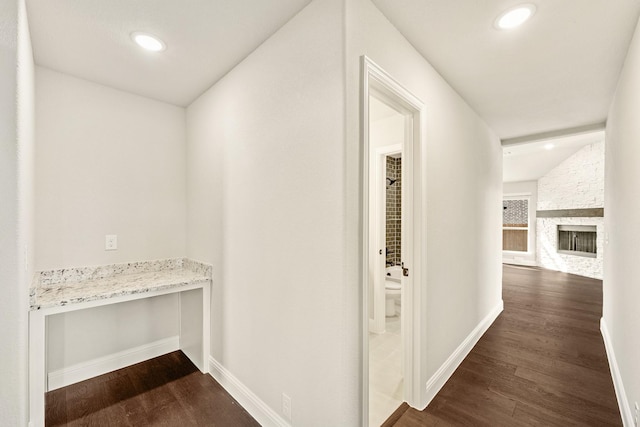 hall featuring dark hardwood / wood-style flooring and vaulted ceiling