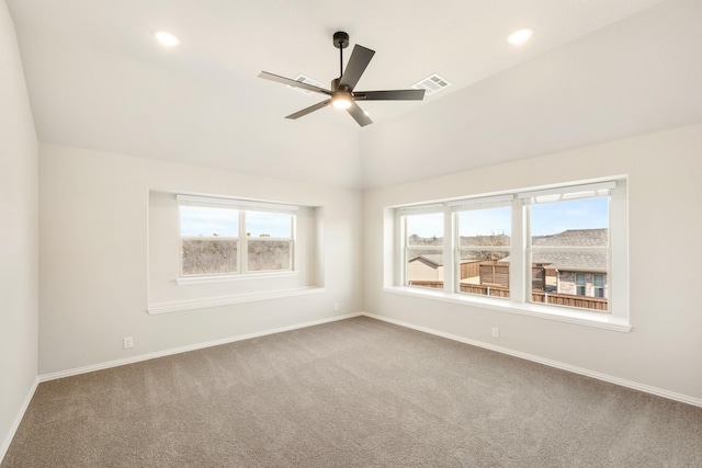 empty room with vaulted ceiling, carpet, and ceiling fan