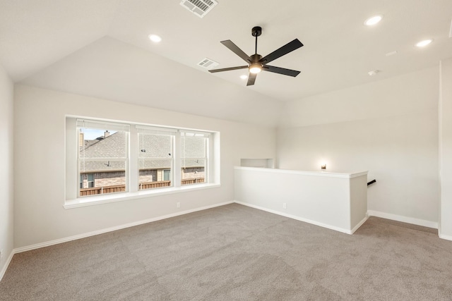 empty room with lofted ceiling, carpet, and ceiling fan