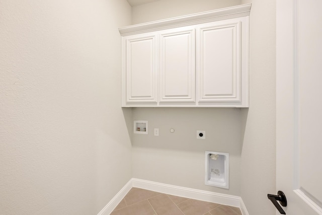 clothes washing area with light tile patterned floors, cabinets, washer hookup, hookup for a gas dryer, and hookup for an electric dryer