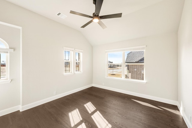 empty room featuring dark hardwood / wood-style flooring, lofted ceiling, and ceiling fan