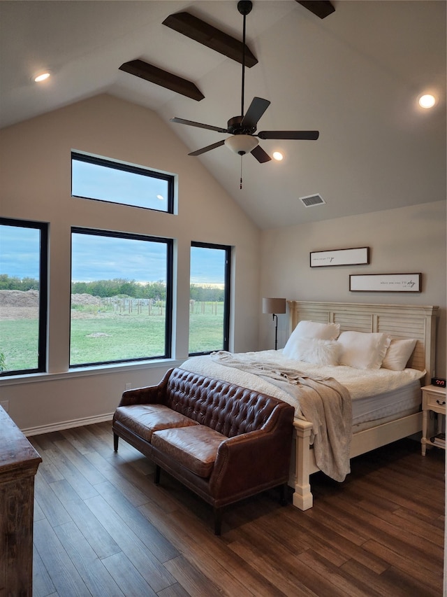 bedroom featuring ceiling fan, dark wood-type flooring, and multiple windows