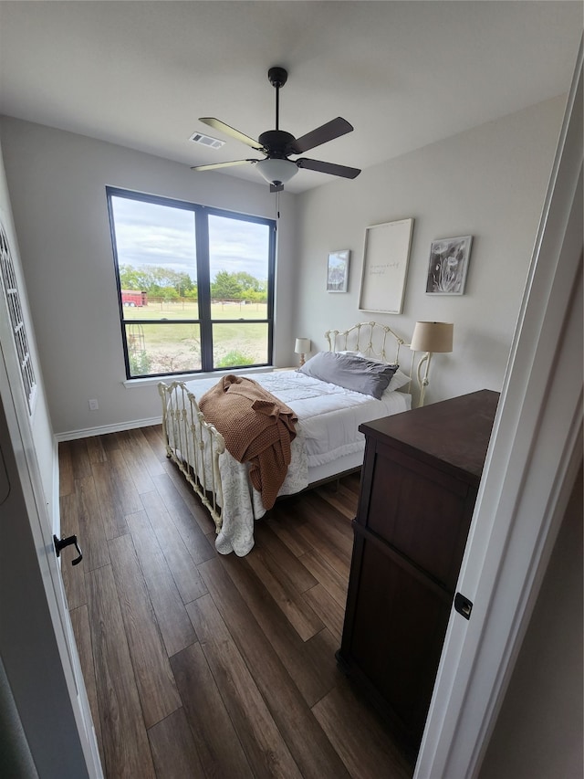 bedroom featuring ceiling fan and dark hardwood / wood-style floors