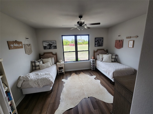 bedroom with ceiling fan and dark hardwood / wood-style floors