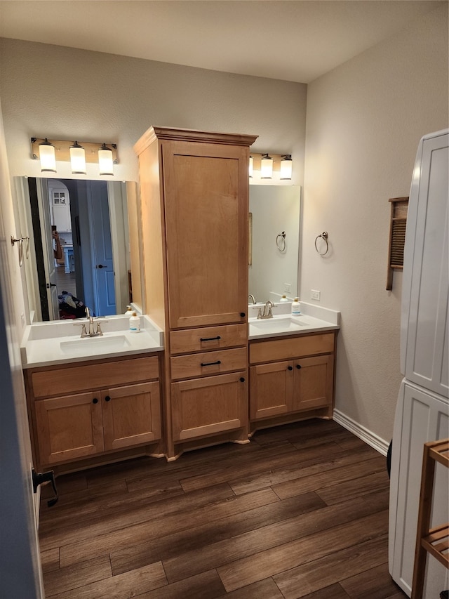 bathroom with hardwood / wood-style flooring and vanity