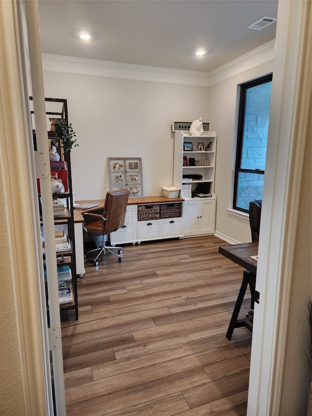 office featuring hardwood / wood-style flooring and crown molding