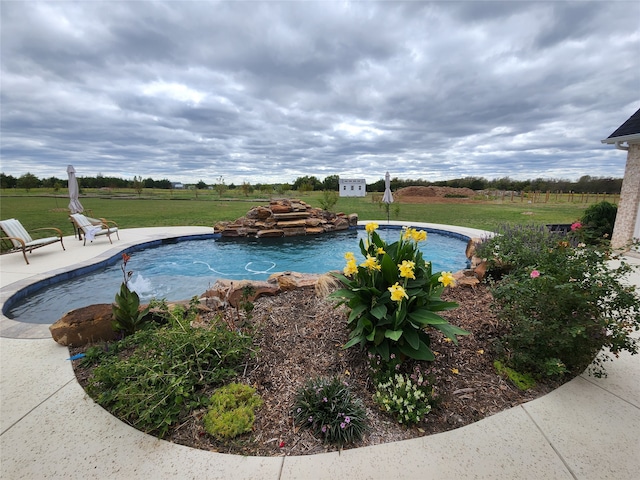 view of swimming pool with a yard and a patio area