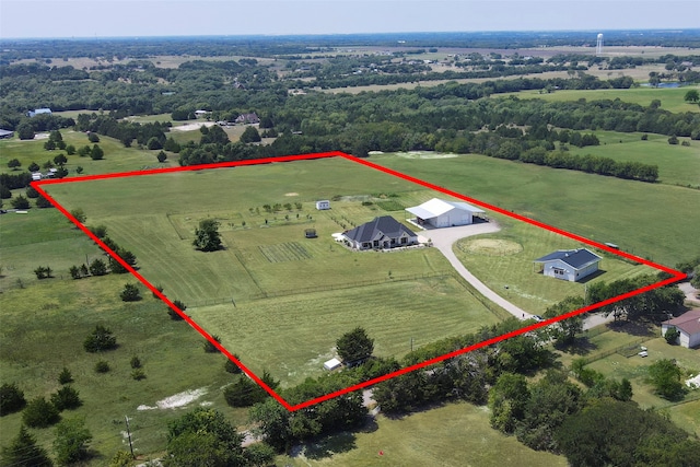 birds eye view of property with a rural view