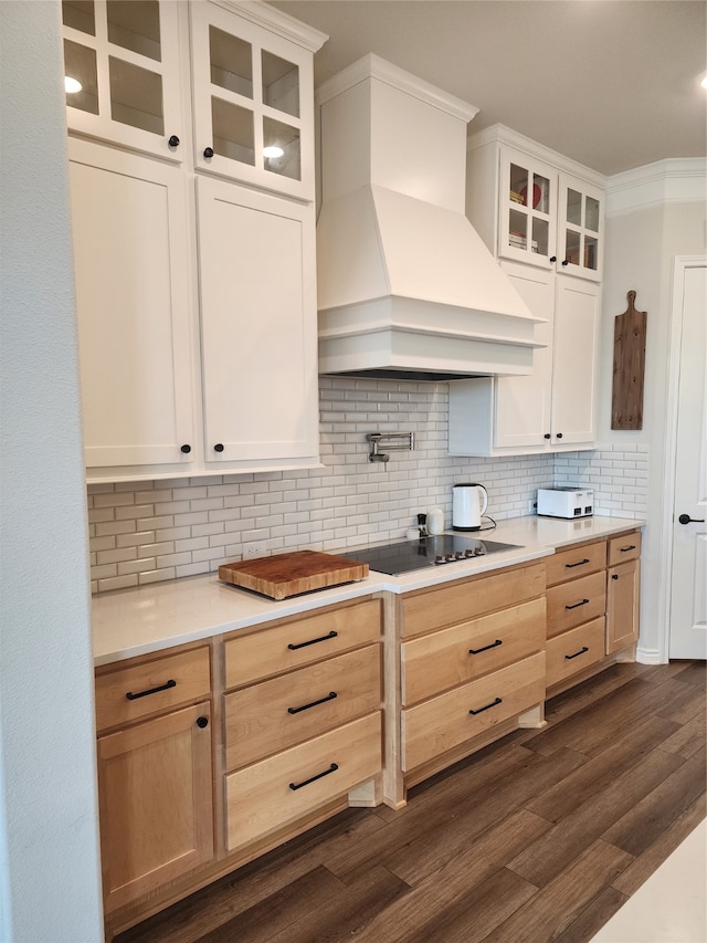 kitchen with ornamental molding, backsplash, custom range hood, black electric stovetop, and dark hardwood / wood-style flooring