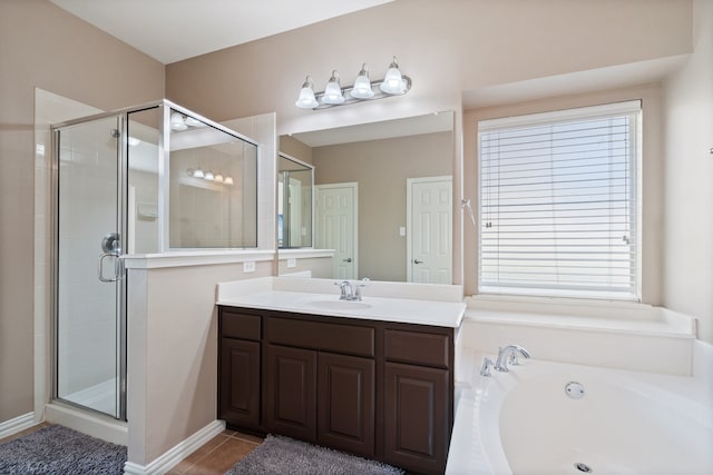 bathroom featuring tile patterned flooring, vanity, and separate shower and tub