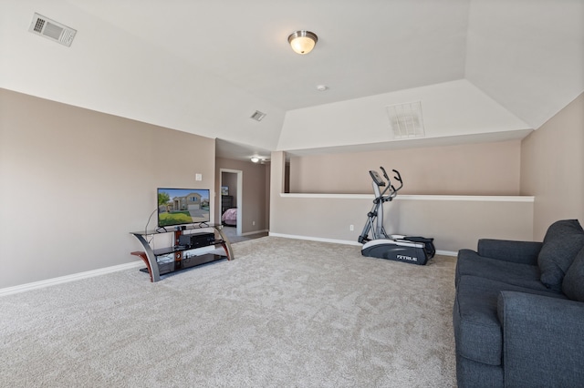 exercise room with vaulted ceiling and carpet flooring