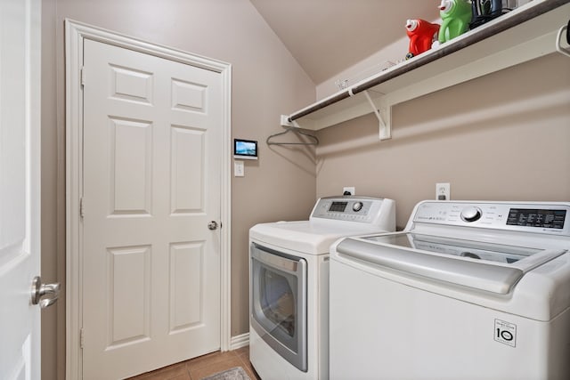 laundry room featuring light tile patterned floors and washer and dryer