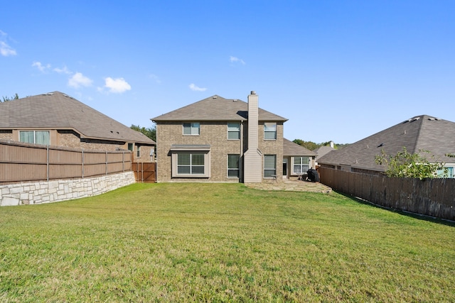 back of house featuring a lawn