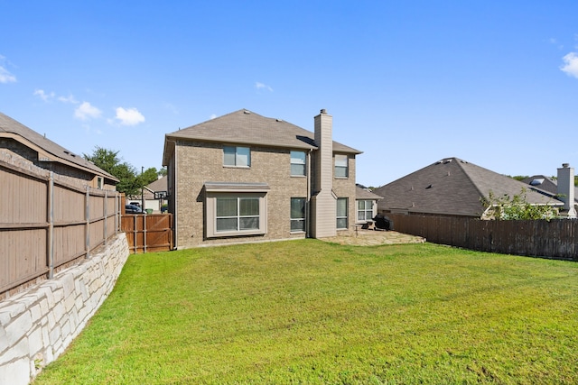 rear view of house with a yard