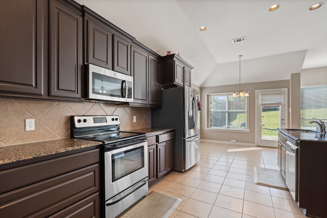 kitchen with lofted ceiling, tasteful backsplash, dark brown cabinets, stainless steel appliances, and an inviting chandelier