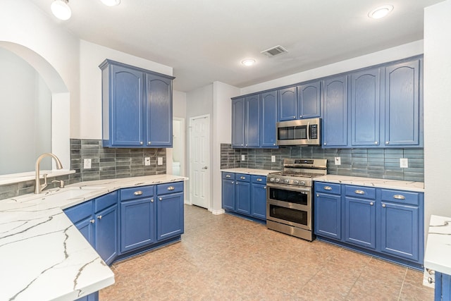 kitchen with sink, blue cabinets, and stainless steel appliances