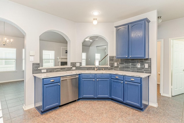 kitchen featuring dishwasher, backsplash, ceiling fan with notable chandelier, light tile patterned floors, and blue cabinetry