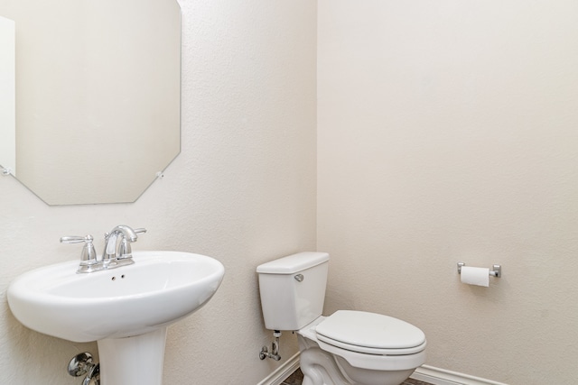 bathroom featuring sink and toilet