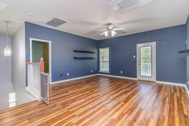 spare room with hardwood / wood-style floors and ceiling fan