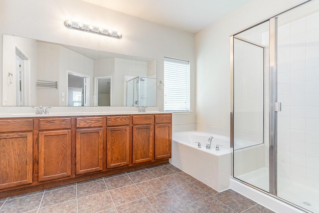 bathroom with plus walk in shower, vanity, and tile patterned flooring