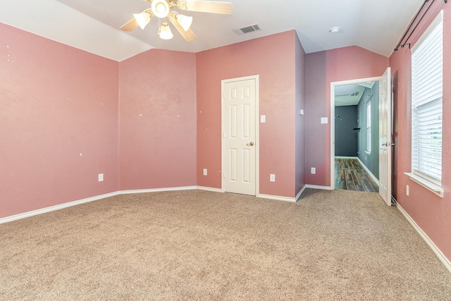 unfurnished bedroom with carpet floors, vaulted ceiling, and ceiling fan