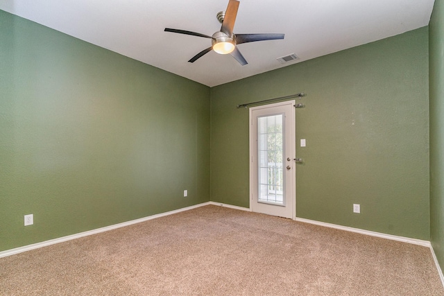 carpeted empty room featuring ceiling fan