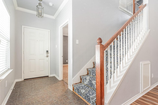 foyer entrance featuring crown molding