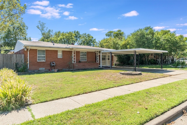 ranch-style house featuring a front yard and a carport