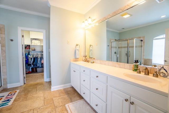 bathroom featuring walk in shower, crown molding, and vanity