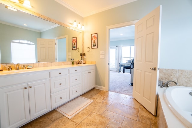 bathroom featuring tiled tub, vanity, and crown molding