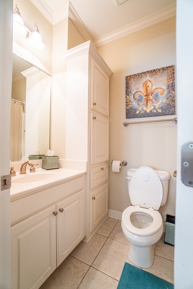 bathroom with tile patterned floors, crown molding, vanity, and toilet