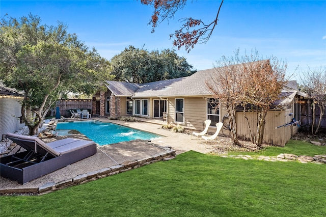 view of swimming pool with a storage unit, a lawn, a patio area, and pool water feature