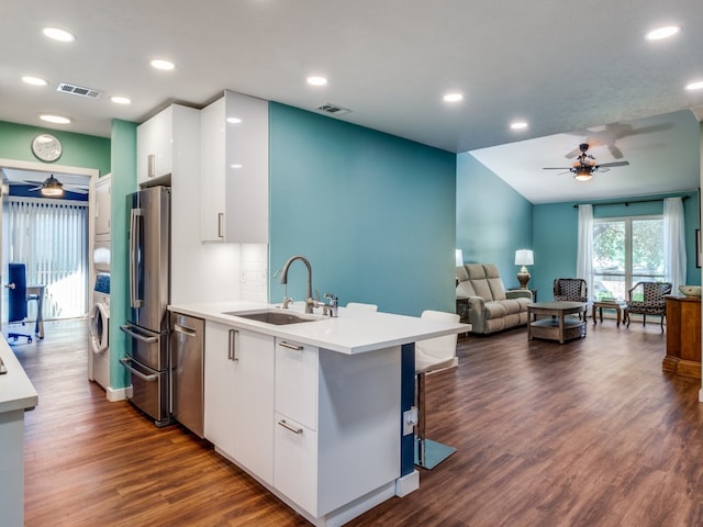 kitchen featuring white cabinets, stainless steel appliances, dark wood-type flooring, and sink