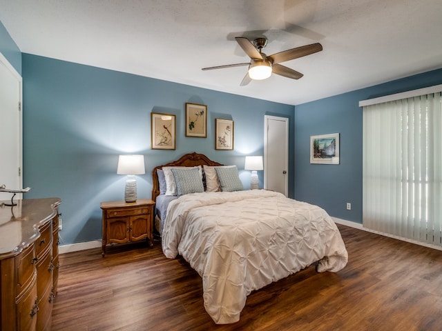 bedroom featuring ceiling fan and dark wood-type flooring