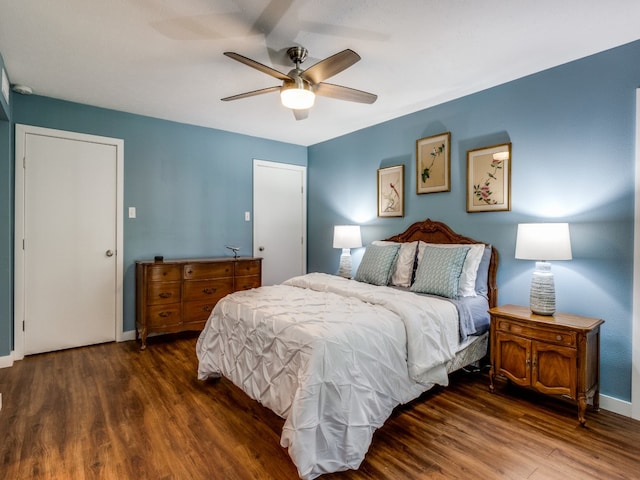 bedroom featuring ceiling fan and dark wood-type flooring