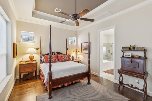 bedroom featuring connected bathroom, multiple windows, ceiling fan, and dark hardwood / wood-style flooring