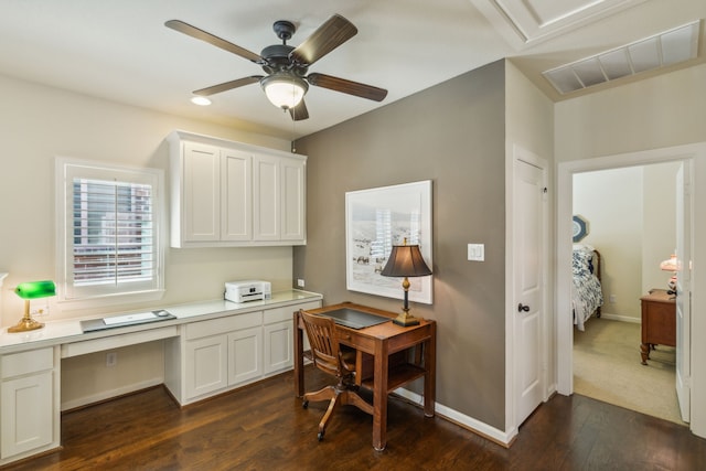 office area featuring built in desk, ceiling fan, and dark hardwood / wood-style flooring