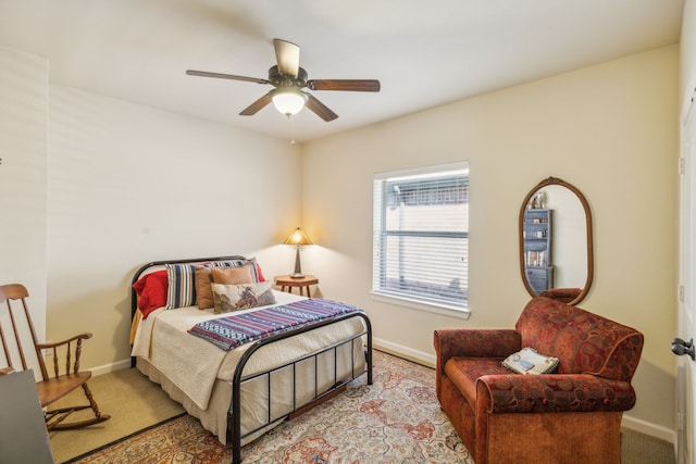 bedroom featuring light carpet and ceiling fan